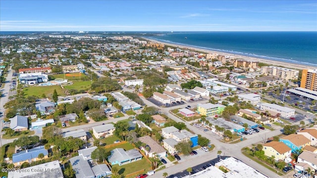 drone / aerial view featuring a water view and a view of the beach