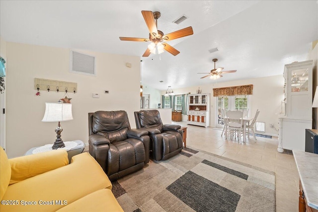 living area with lofted ceiling, light tile patterned flooring, and visible vents