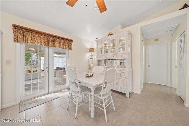 dining area with lofted ceiling, ceiling fan, light tile patterned floors, and baseboards