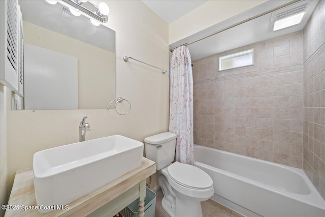 full bath featuring shower / bath combo, visible vents, a sink, and toilet