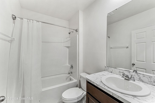 bathroom with shower / bathtub combination with curtain, vanity, and toilet