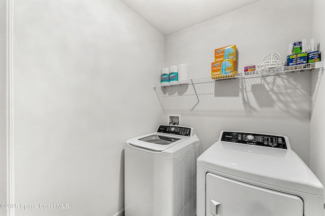 laundry room with laundry area and washing machine and clothes dryer