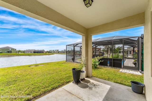 view of patio with a water view and a lanai