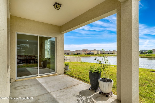 view of patio with a water view and a residential view