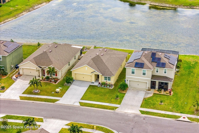 drone / aerial view featuring a residential view and a water view