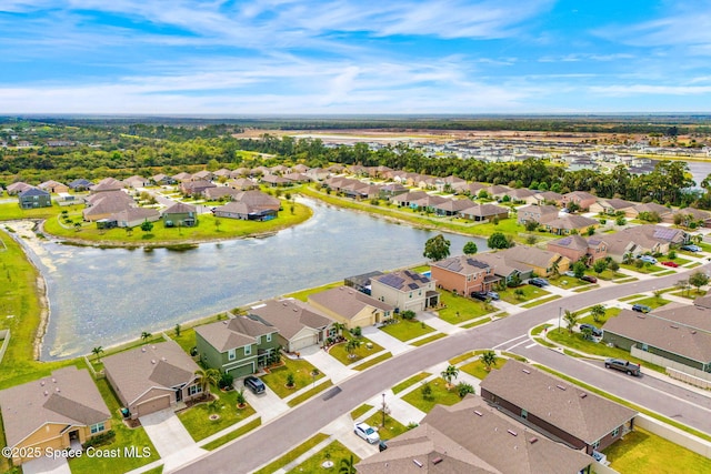 birds eye view of property featuring a water view and a residential view