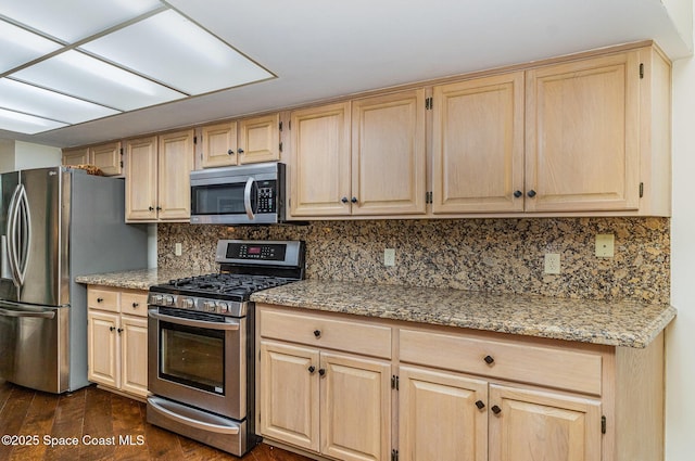 kitchen featuring dark wood-style floors, light brown cabinetry, appliances with stainless steel finishes, and decorative backsplash