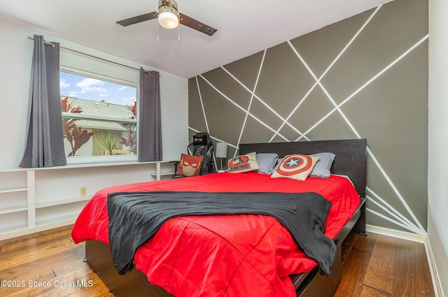 bedroom featuring a textured ceiling, a ceiling fan, and hardwood / wood-style floors