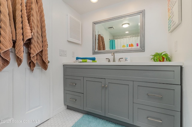 full bath featuring tile patterned flooring, vanity, and baseboards