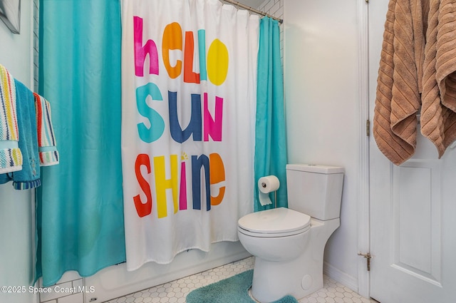 full bathroom featuring toilet, shower / bathtub combination with curtain, and tile patterned floors