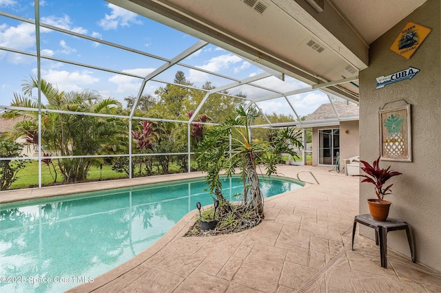 outdoor pool with a lanai and a patio area