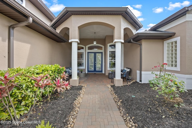 entrance to property with french doors and stucco siding