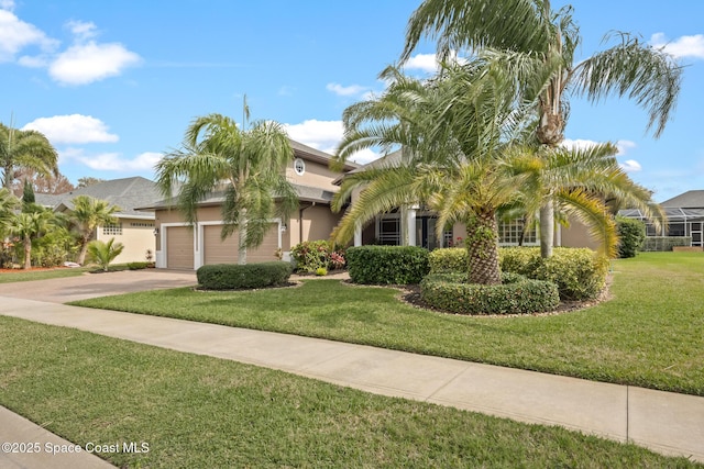 view of front facade with a garage, stucco siding, driveway, and a front yard