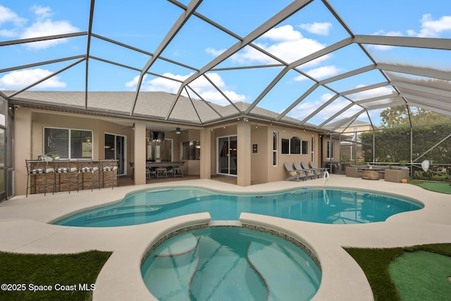 view of swimming pool featuring a lanai, a patio area, outdoor dry bar, and an outdoor kitchen