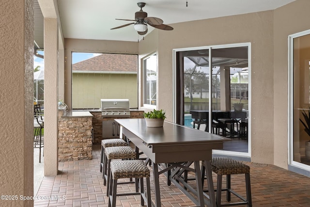 sunroom with a ceiling fan