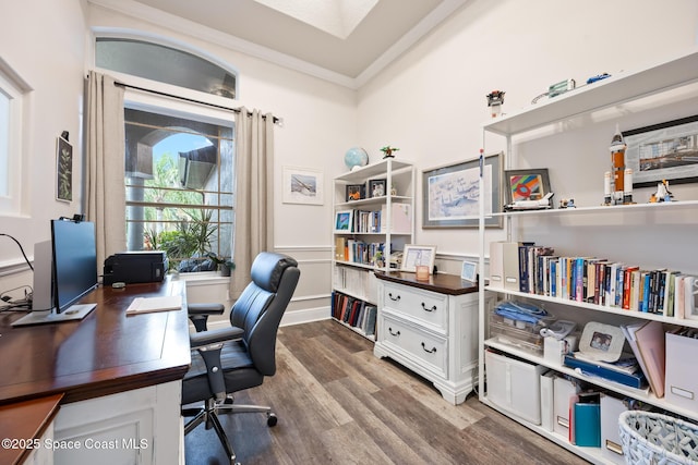 office area featuring ornamental molding, a wainscoted wall, and wood finished floors