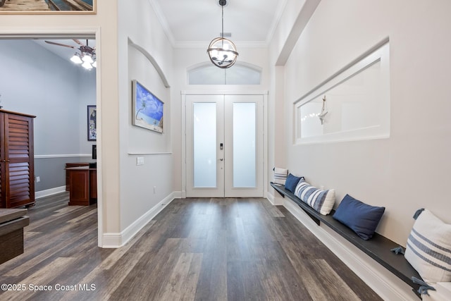 entrance foyer featuring ornamental molding, french doors, dark wood finished floors, and baseboards