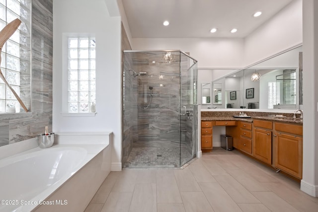 full bathroom with a stall shower, recessed lighting, a garden tub, and vanity