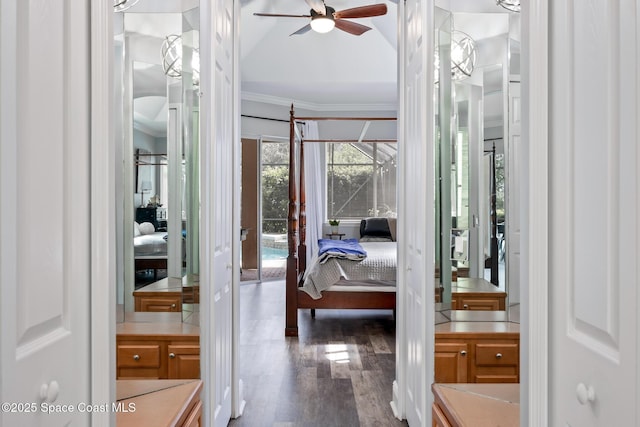 bathroom with connected bathroom, wood finished floors, a ceiling fan, vaulted ceiling, and ornamental molding