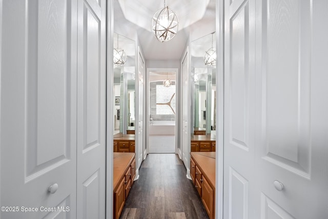 bathroom featuring a chandelier and wood finished floors