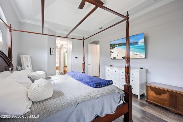 bedroom with arched walkways, crown molding, ensuite bathroom, and wood finished floors