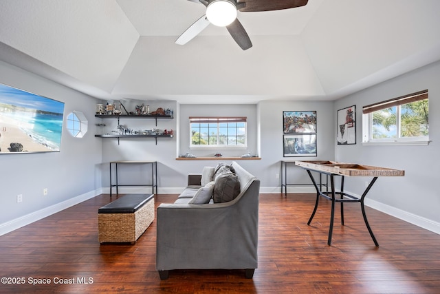 living room featuring lofted ceiling, dark wood finished floors, and a wealth of natural light