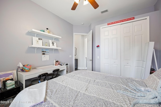 bedroom with a ceiling fan, visible vents, and a closet