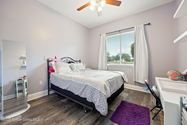 bedroom featuring lofted ceiling, dark wood-style flooring, ceiling fan, and baseboards