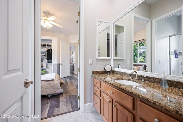 full bathroom with a ceiling fan, connected bathroom, vanity, and tile patterned floors