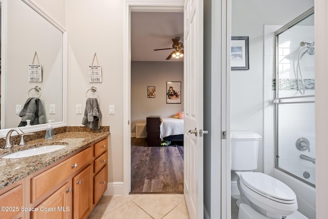 bathroom featuring toilet, ceiling fan, connected bathroom, vanity, and tile patterned floors