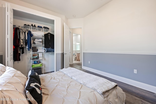 bedroom featuring a closet, baseboards, and wood finished floors