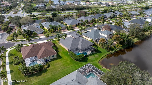 drone / aerial view featuring a residential view and a water view