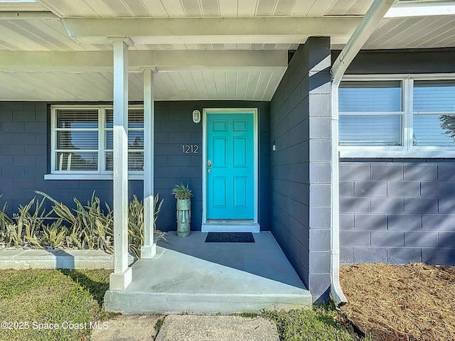 property entrance featuring concrete block siding