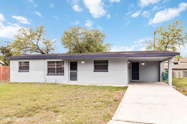 ranch-style home featuring driveway, fence, a front lawn, and brick siding