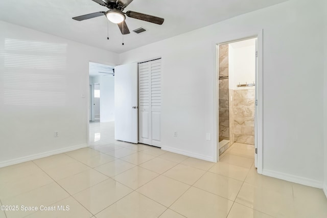 unfurnished bedroom featuring light tile patterned floors, a closet, visible vents, a ceiling fan, and baseboards