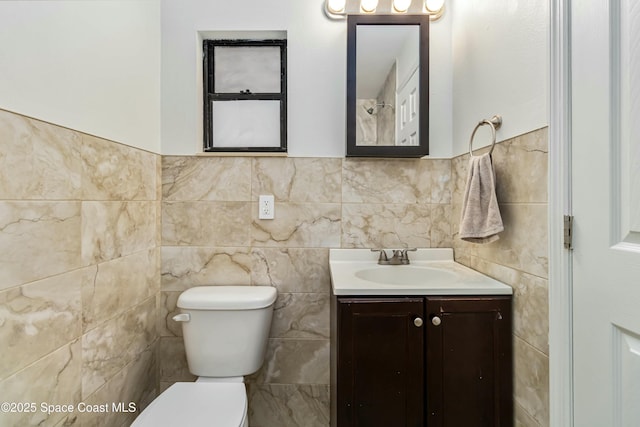 full bath featuring tile walls, vanity, and toilet