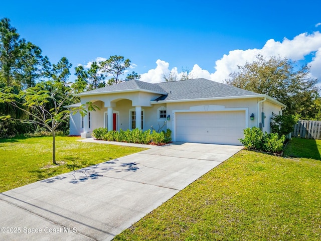 ranch-style home with stucco siding, a shingled roof, a front yard, a garage, and driveway