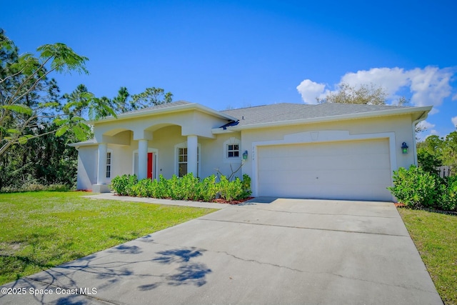 view of front of home with a garage, driveway, a shingled roof, a front yard, and stucco siding