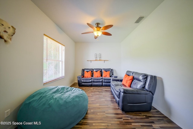 living area featuring a ceiling fan, visible vents, and wood finished floors