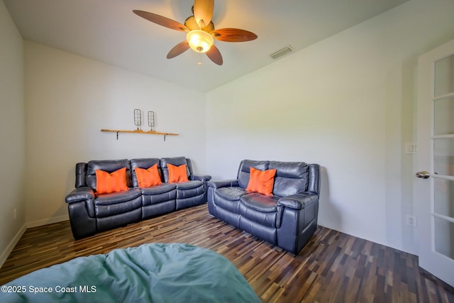 living area with baseboards, ceiling fan, visible vents, and wood finished floors