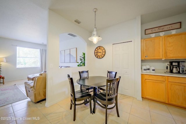 dining area featuring visible vents and light tile patterned flooring