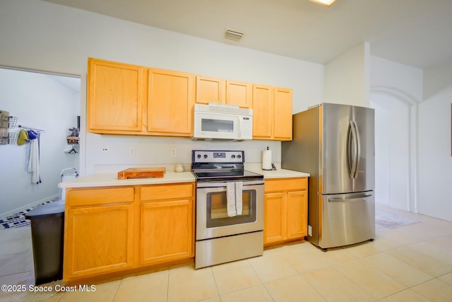 kitchen with light tile patterned floors, visible vents, appliances with stainless steel finishes, and light countertops