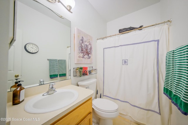 bathroom with a shower with curtain, vanity, toilet, and tile patterned floors