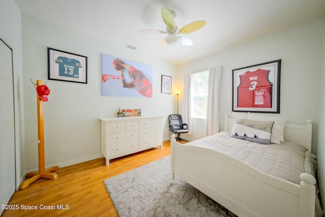 bedroom with light wood-type flooring, baseboards, visible vents, and a ceiling fan