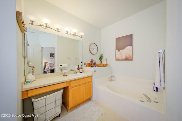 ensuite bathroom featuring a garden tub, vanity, and ensuite bathroom