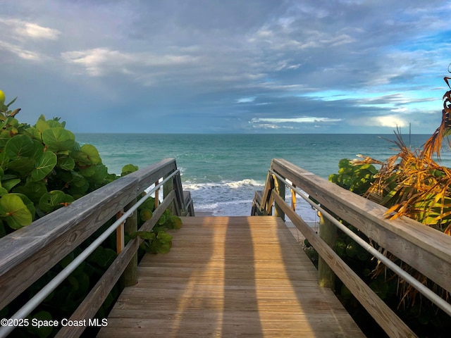 view of home's community with a beach view and a water view