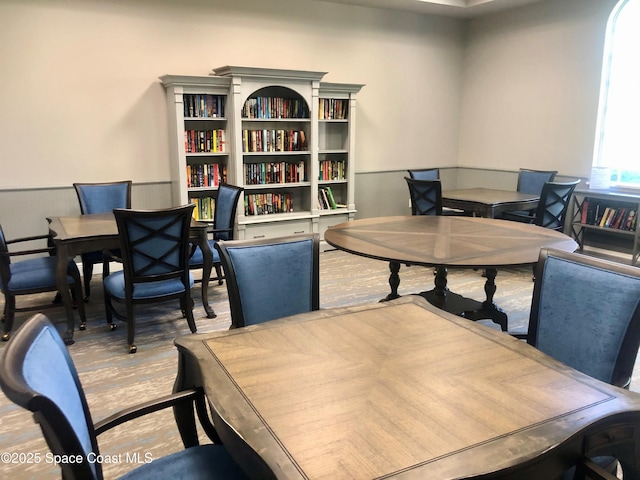 office area with wood finished floors and wainscoting