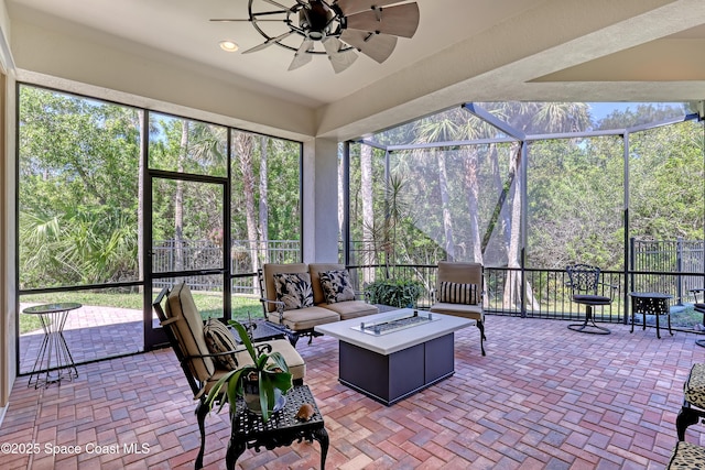 sunroom / solarium featuring plenty of natural light and ceiling fan