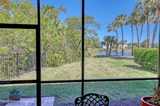 unfurnished sunroom featuring a water view and a wealth of natural light