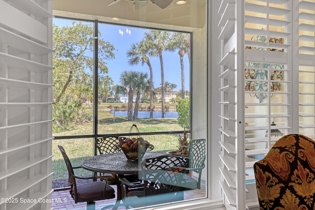 sunroom / solarium with a water view